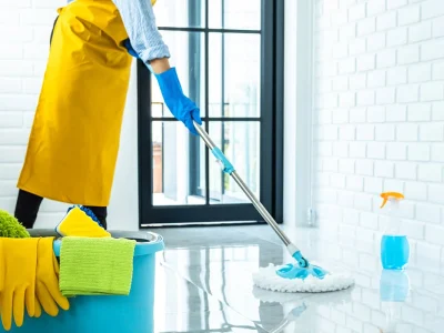 happy-young-woman-blue-rubber-using-mop-while-cleaning-floor-home.webp